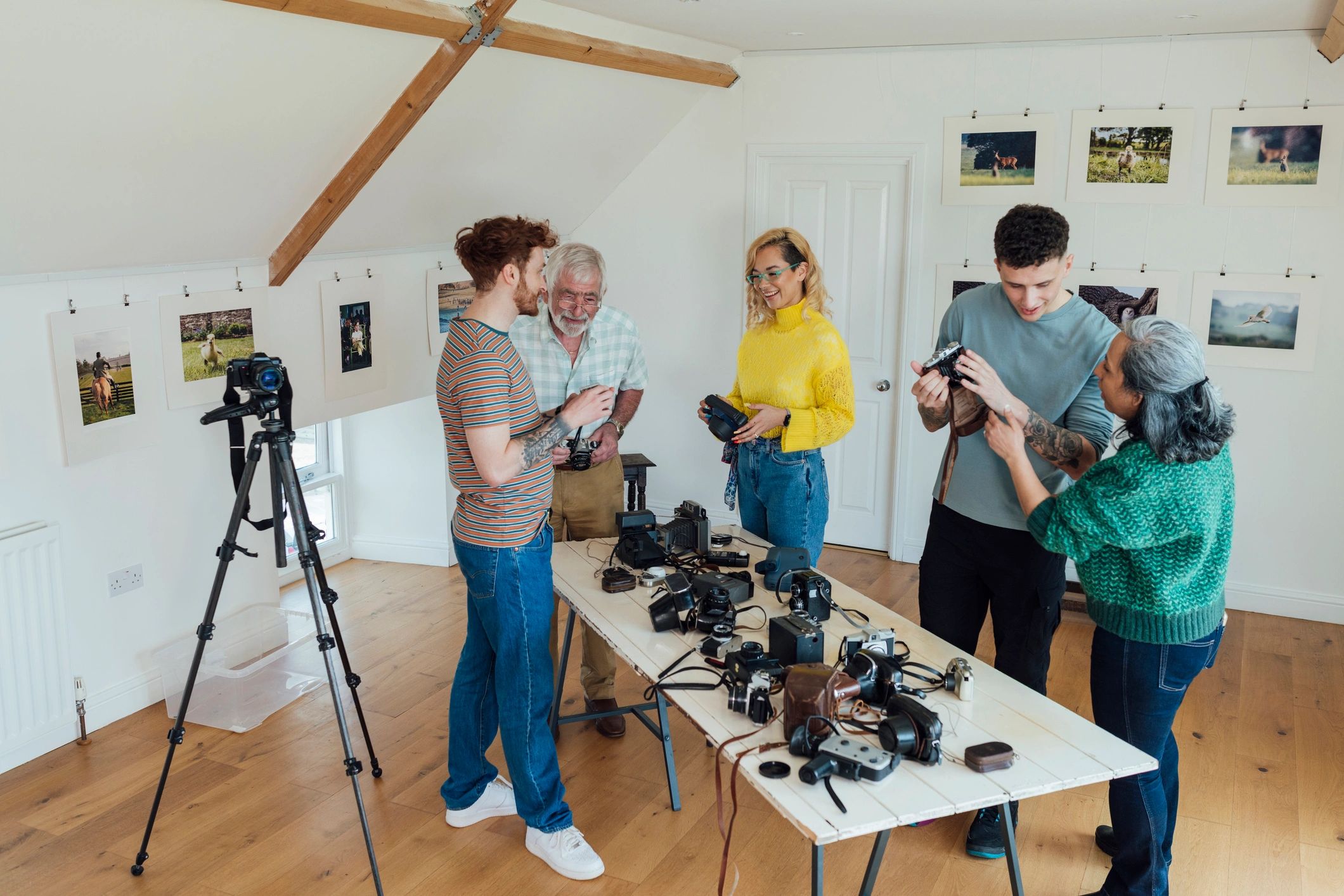 Creative team discussing cameras in an art gallery